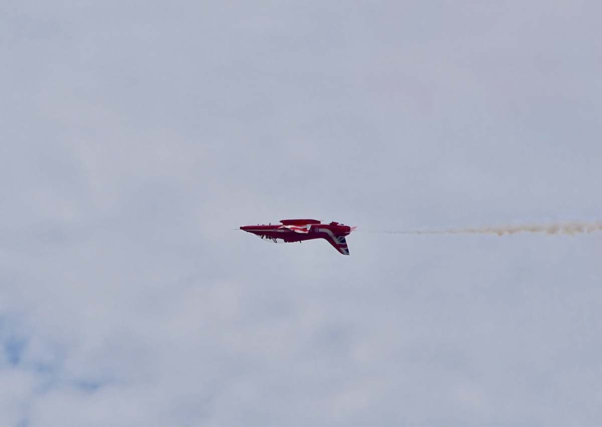 leisure activities red airplane flying under cloudy sky during daytime animal